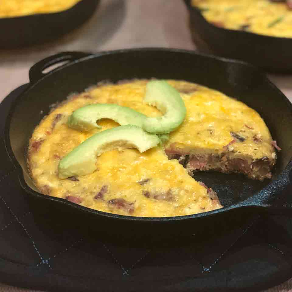 A cheesy beef frittata with avocado sliced on top