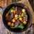 Braised Short Ribs Dinner Recipe with falll vegetables in a cast iron skillet
